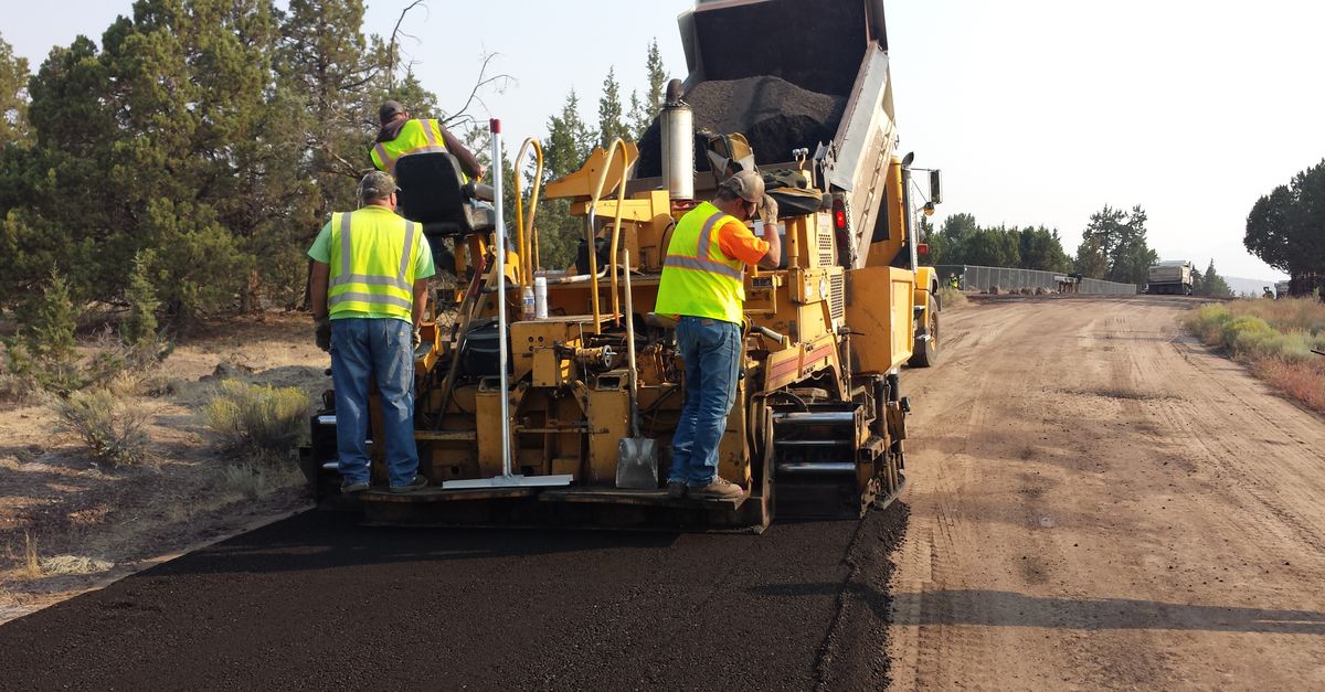 Road construction crew working on asphalt
